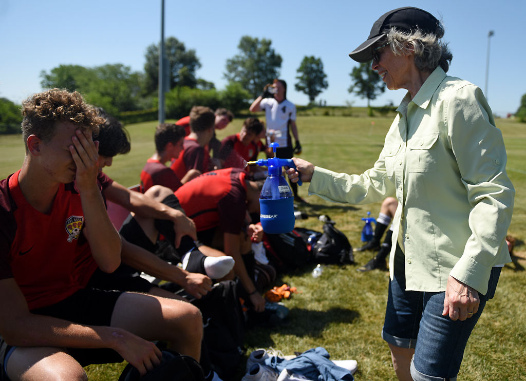 Dayna Glanz sprinkles the players of the Carl Rose Soccer Academy with water